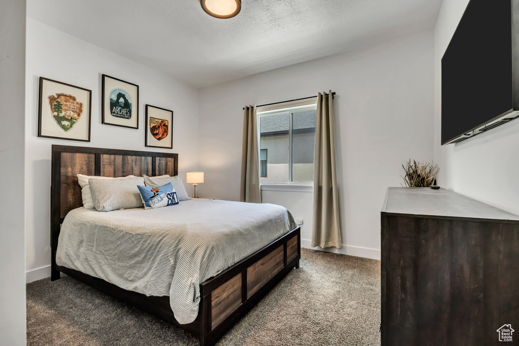 Carpeted bedroom featuring baseboards