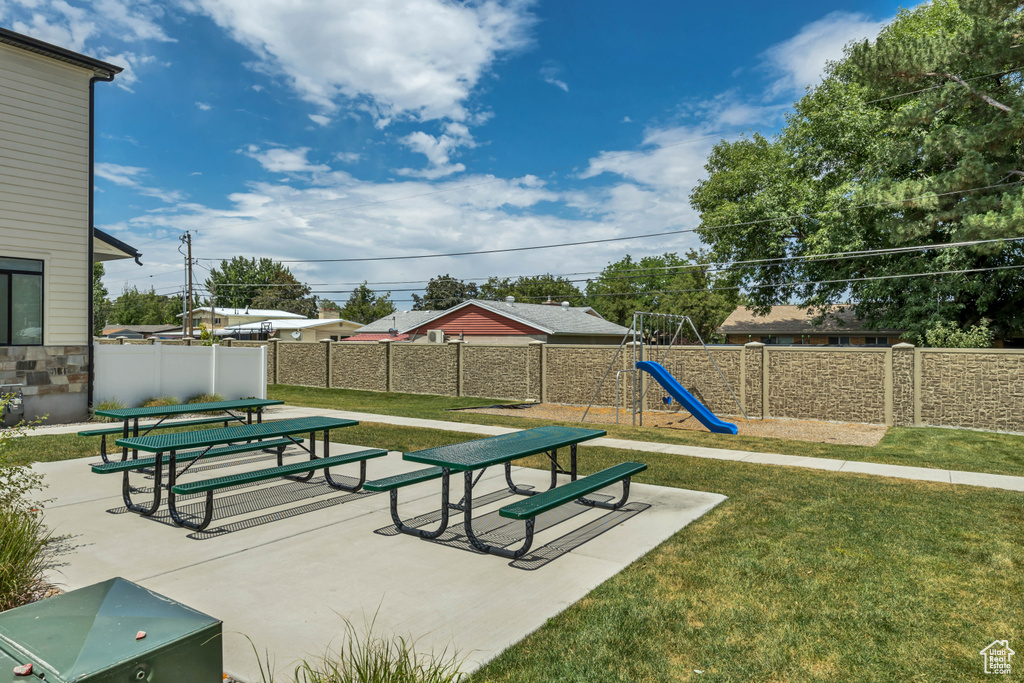 View of property's community with a fenced backyard and a patio area
