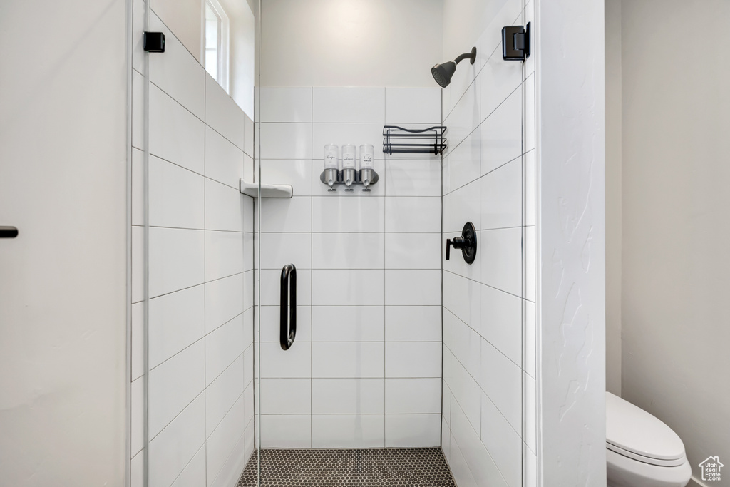 Bathroom with a stall shower and toilet