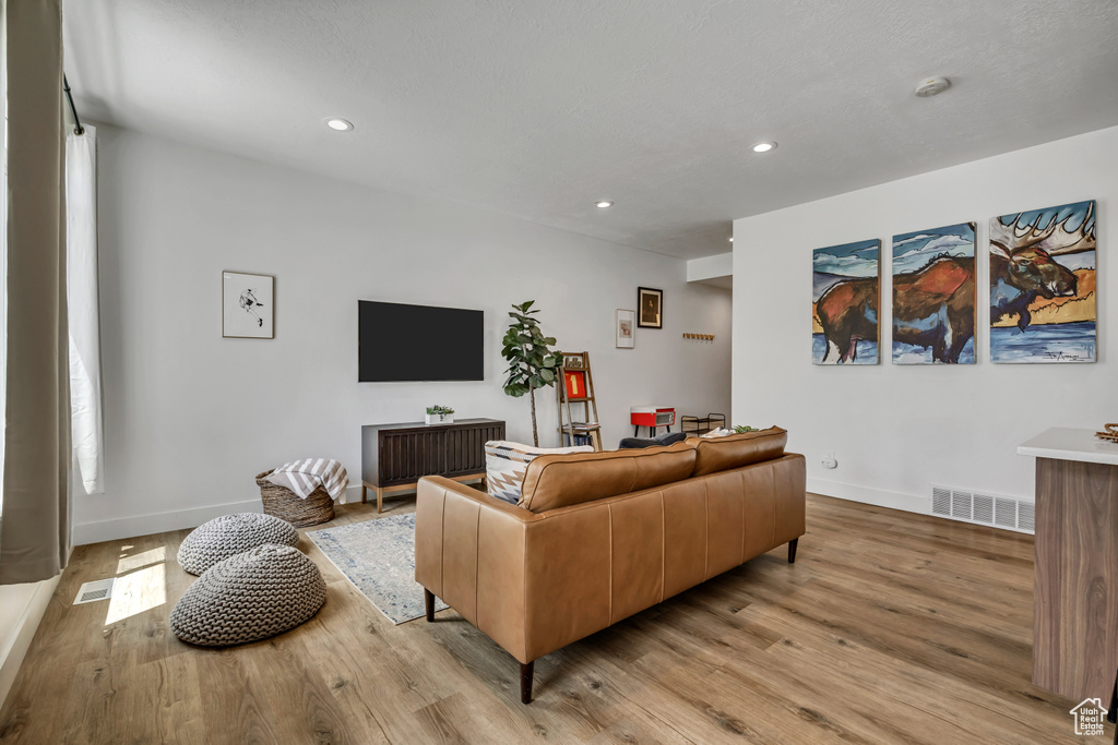Living area featuring light wood-type flooring and recessed lighting