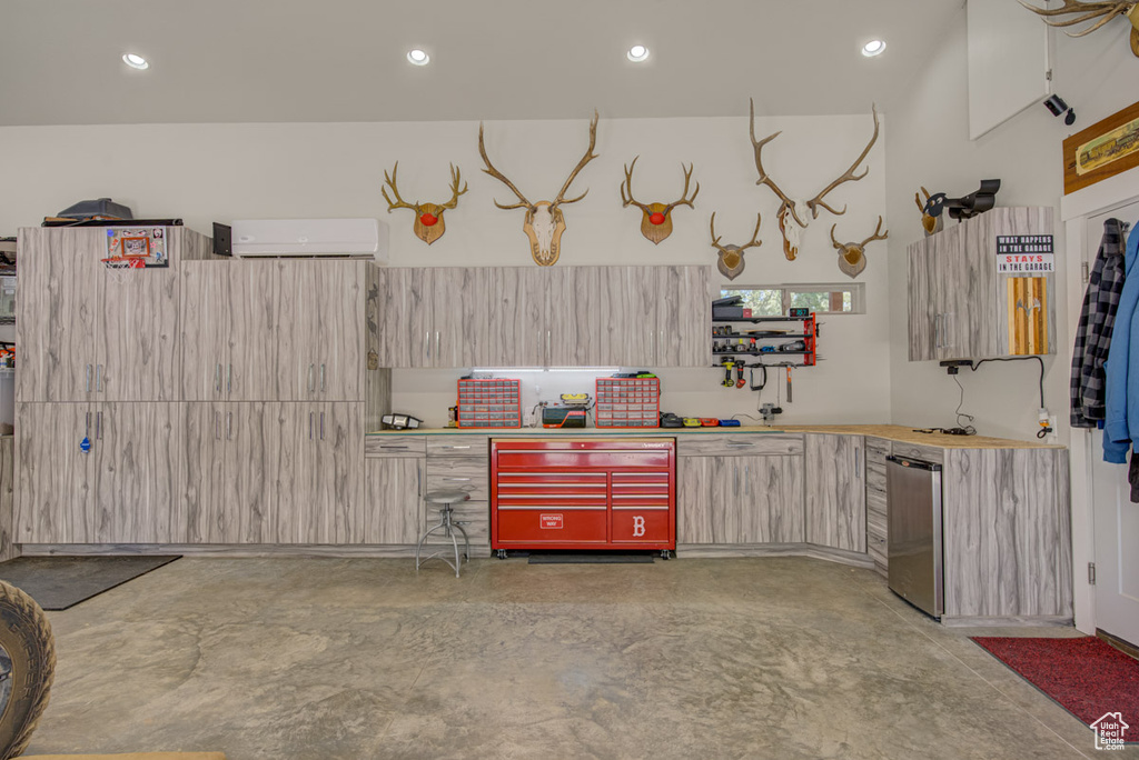 Garage with a wall mounted AC and recessed lighting
