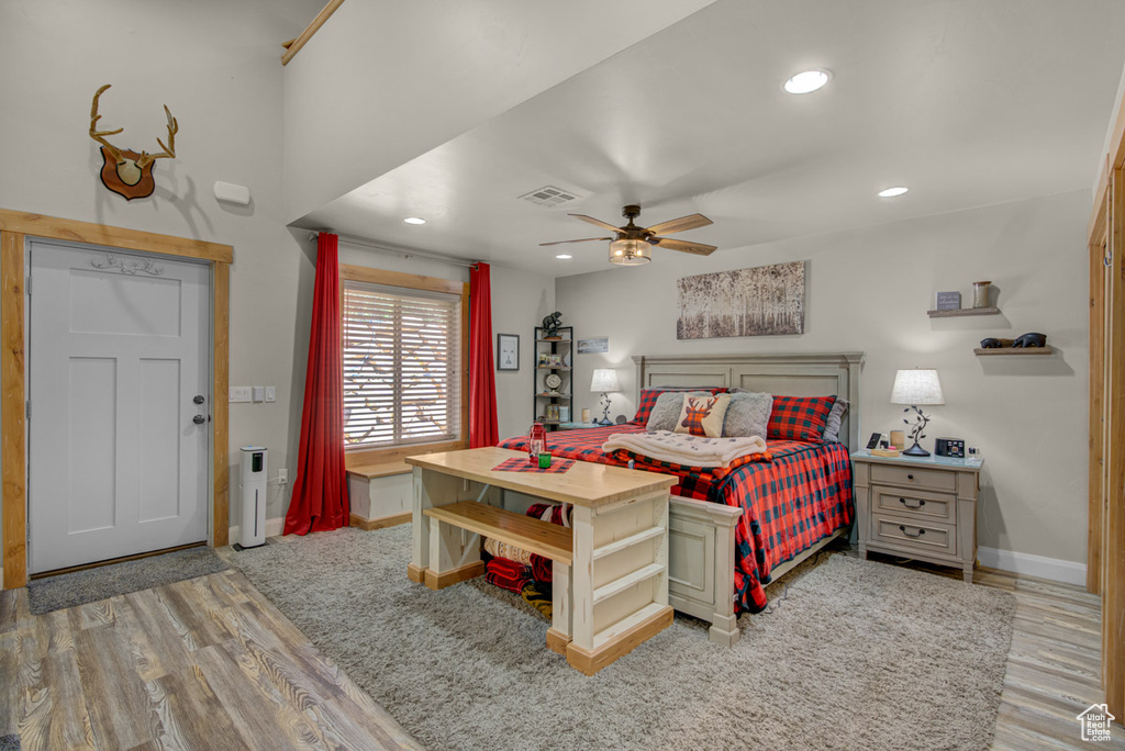 Bedroom with wood finished floors, recessed lighting, and a ceiling fan