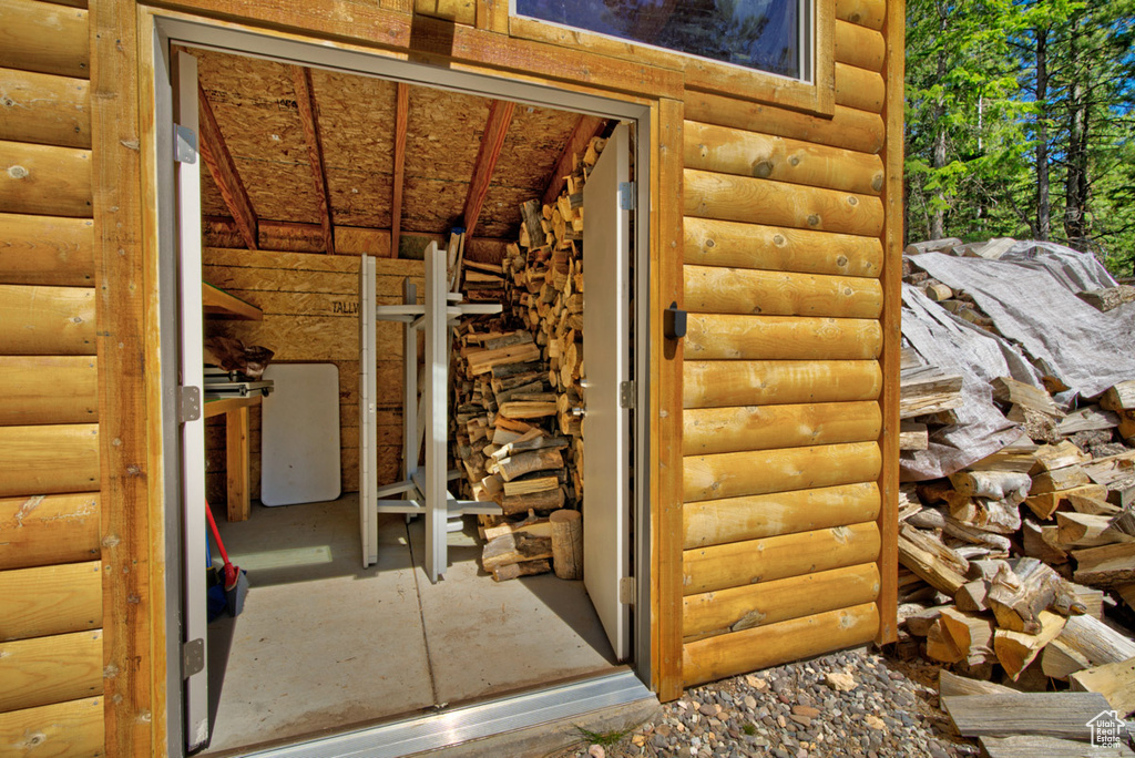 Property entrance featuring faux log siding