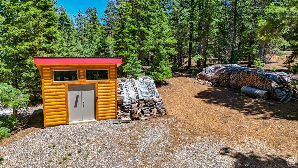 View of shed featuring a view of trees