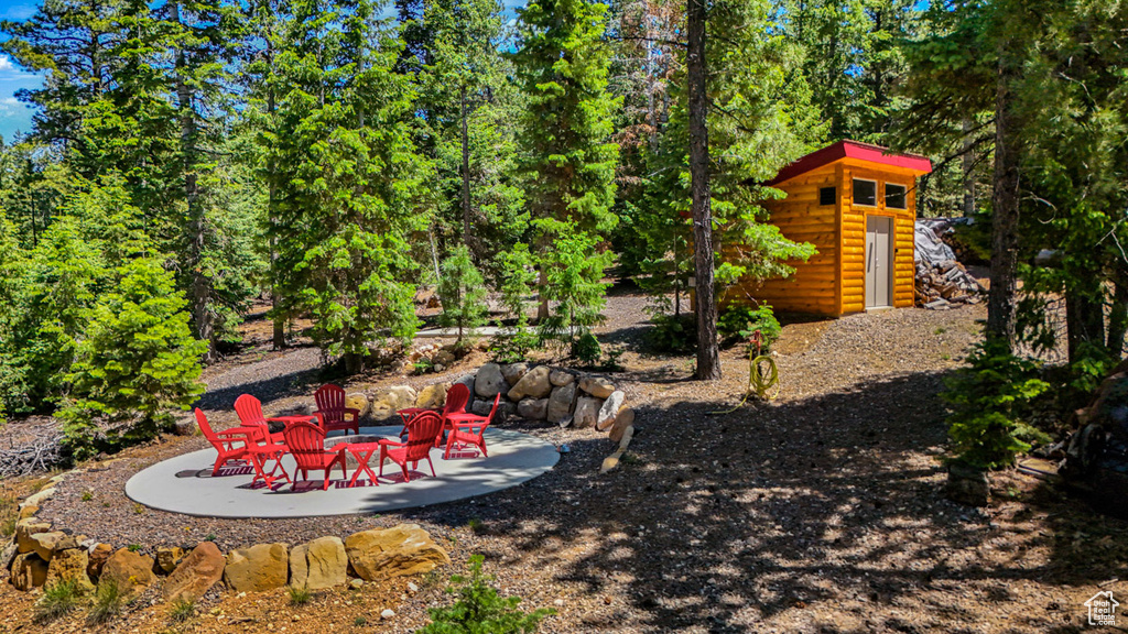 View of yard with an outdoor fire pit and a patio