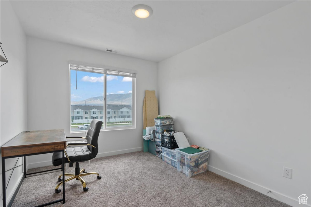 Carpeted office space featuring baseboards