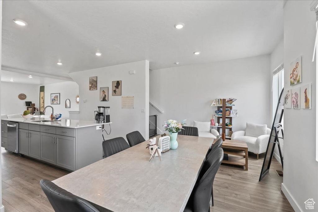 Dining space featuring light wood-type flooring and recessed lighting