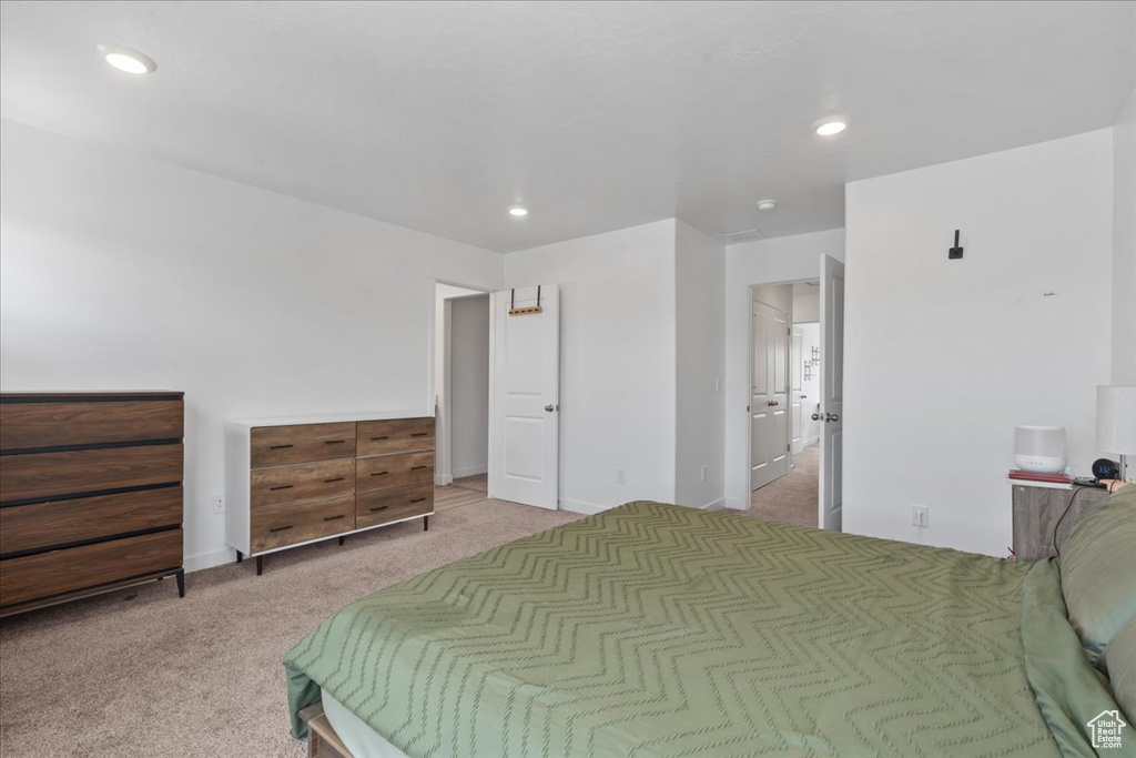 Bedroom with light carpet and recessed lighting