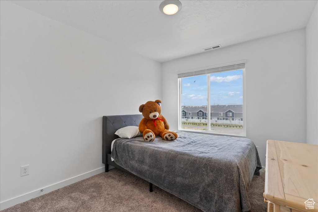 Bedroom with carpet flooring and baseboards
