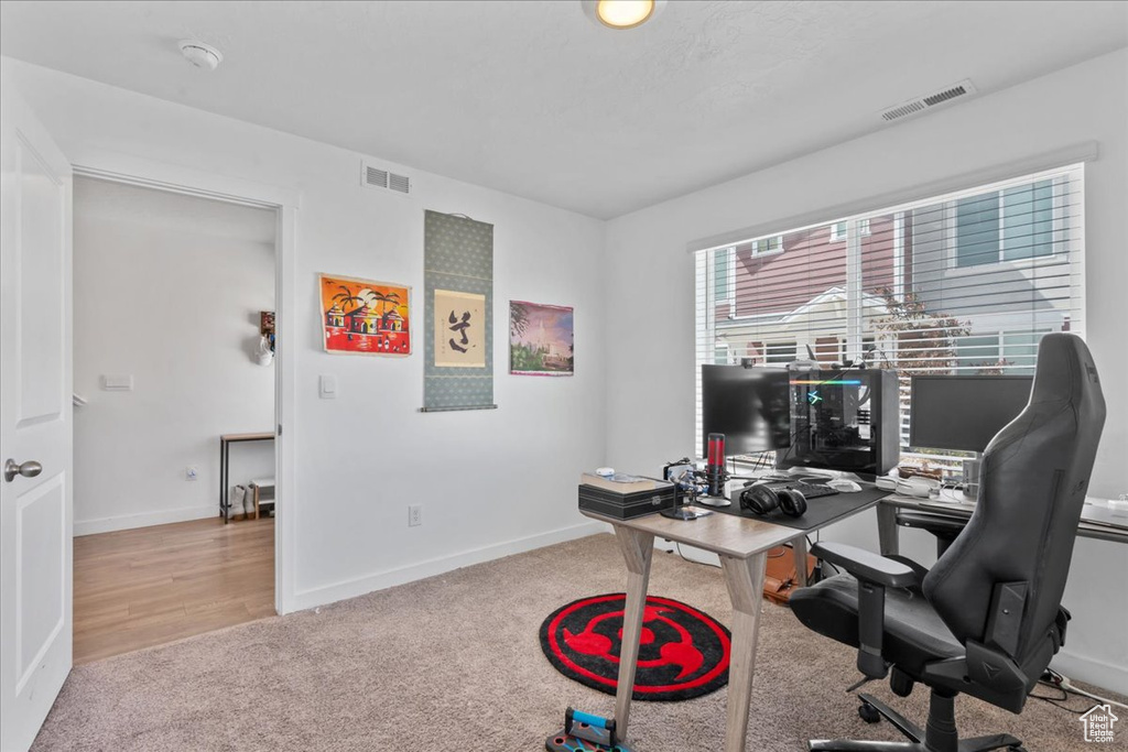 Carpeted office space featuring baseboards