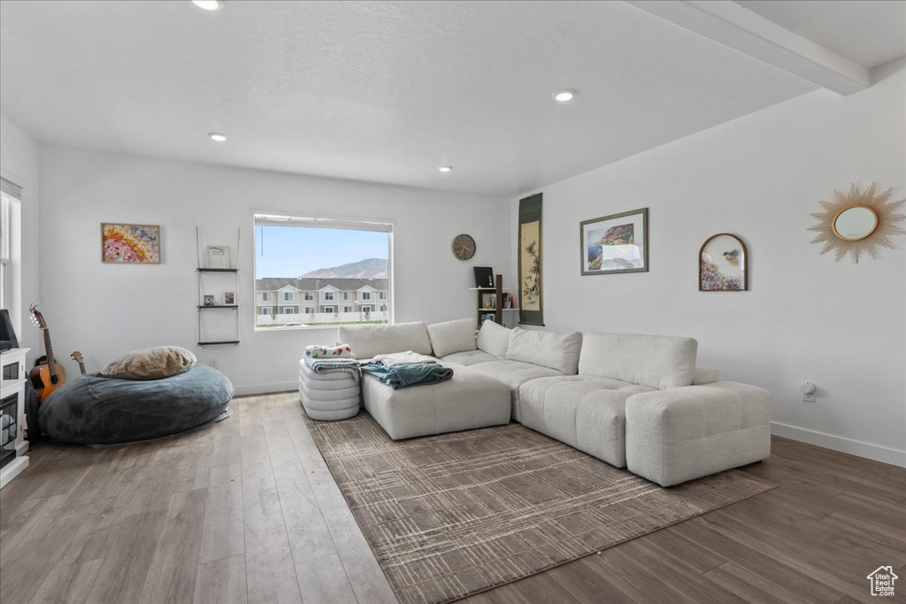 Living area with wood finished floors and recessed lighting