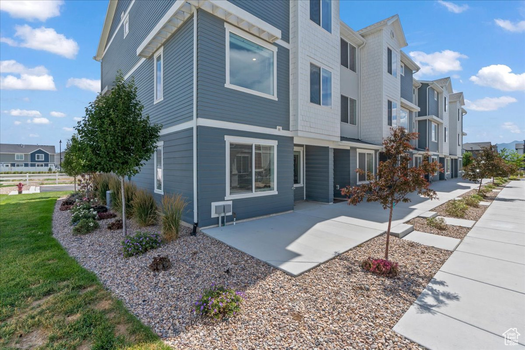 Rear view of property with a residential view and a patio