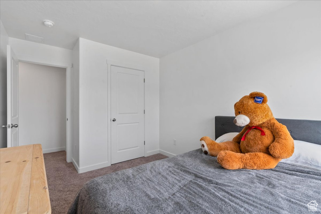 Bedroom featuring carpet flooring and baseboards