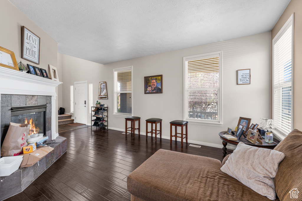 Living area featuring a tile fireplace and wood finished floors