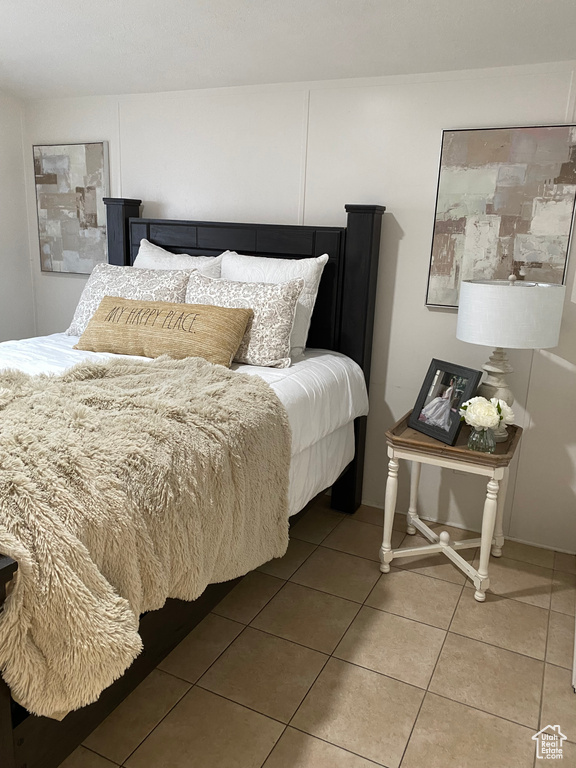 Bedroom with light tile patterned flooring