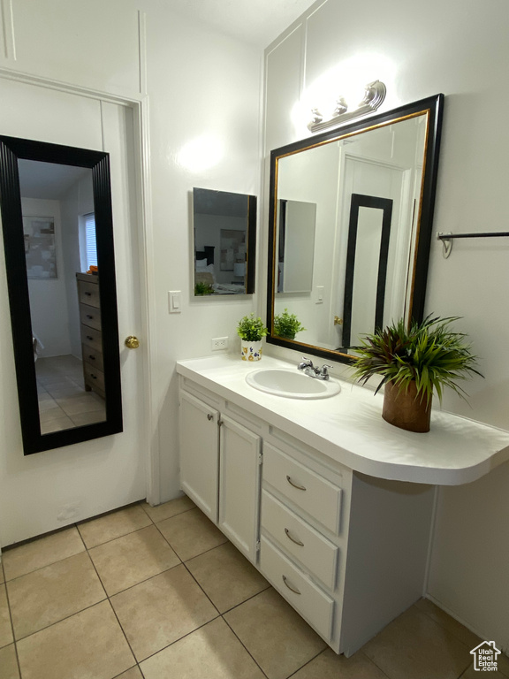 Bathroom with tile patterned floors and vanity