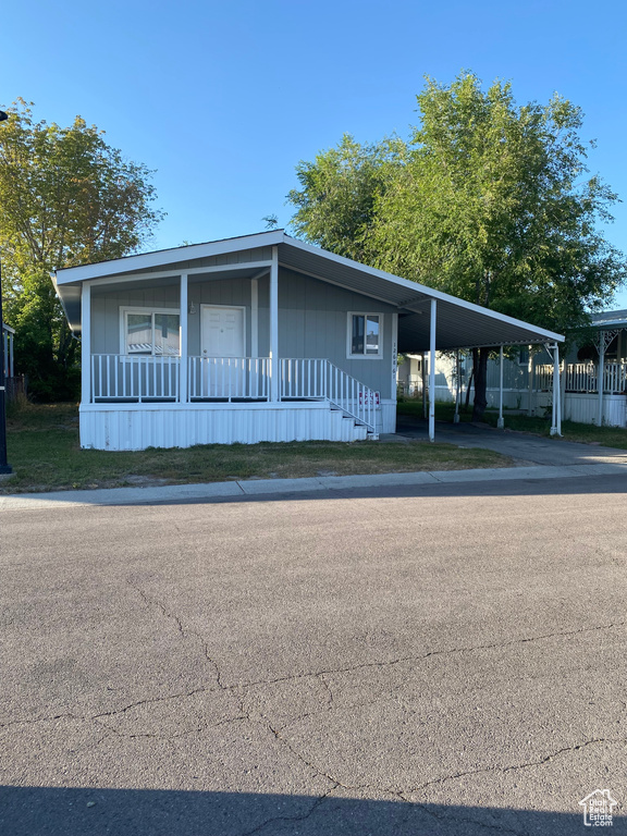 Manufactured / mobile home with a carport and covered porch