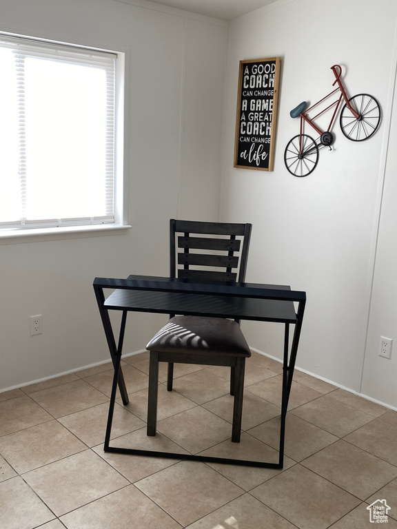 Dining area featuring light tile patterned floors and baseboards