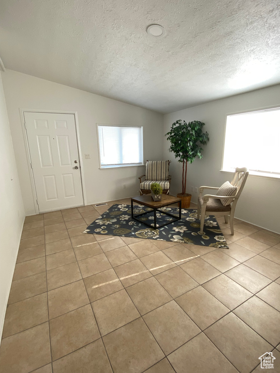 Dining space with tile patterned floors and a textured ceiling