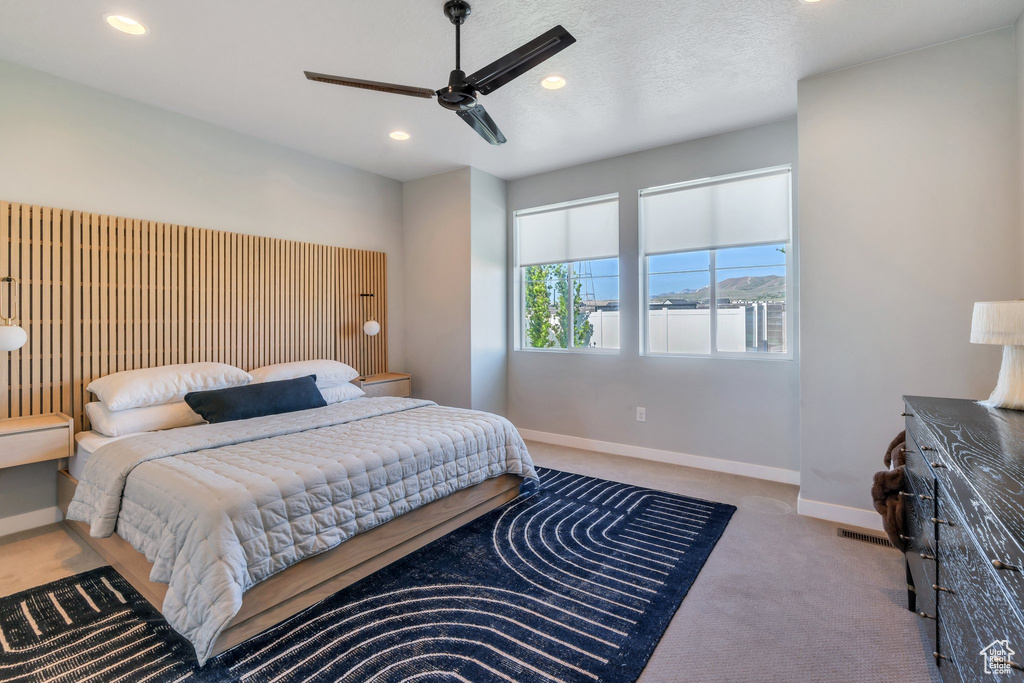 Carpeted bedroom featuring baseboards, recessed lighting, and ceiling fan