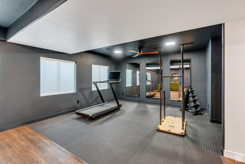 Workout room with baseboards, recessed lighting, a ceiling fan, and wood finished floors