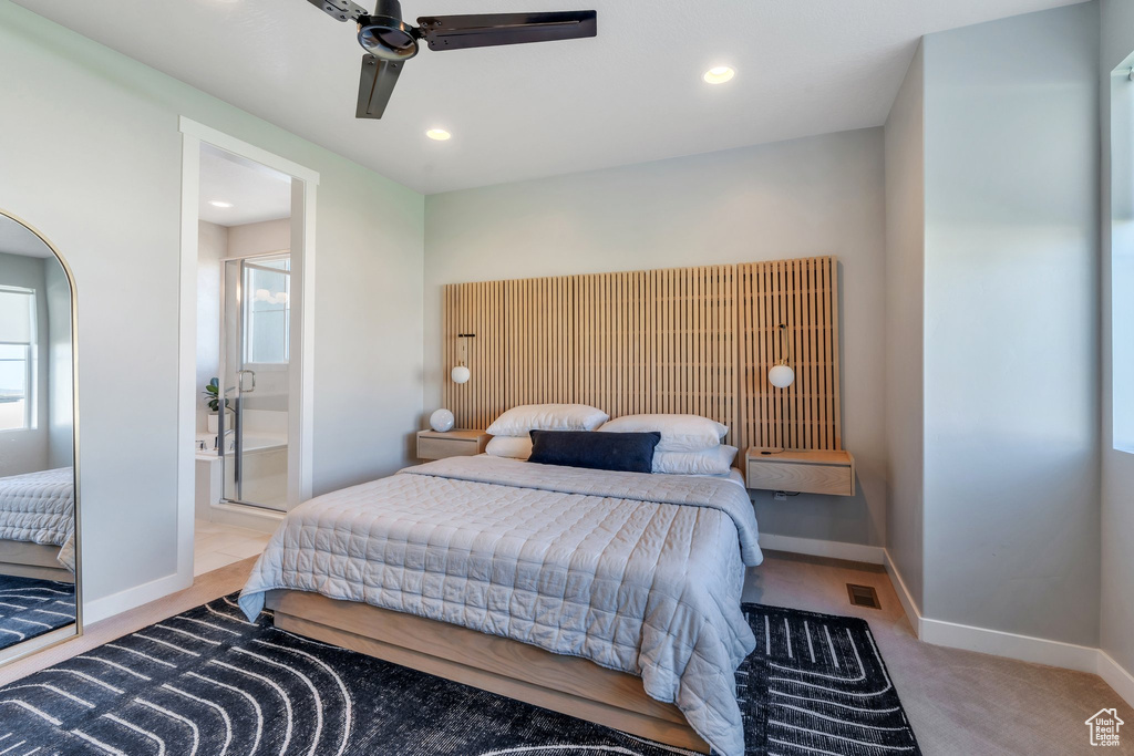 Carpeted bedroom with ensuite bath, recessed lighting, baseboards, and a ceiling fan