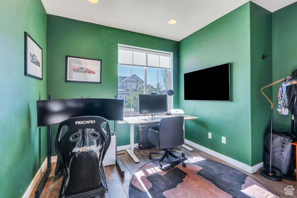 Office space featuring baseboards, wood finished floors, and recessed lighting