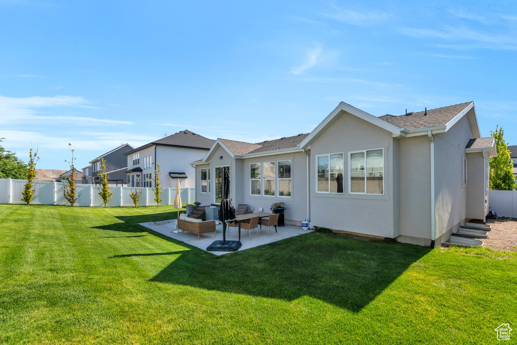 Rear view of property with stucco siding and a patio area