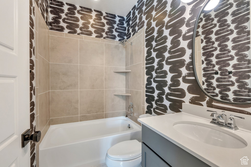 Full bath with toilet, vanity, and shower / tub combination