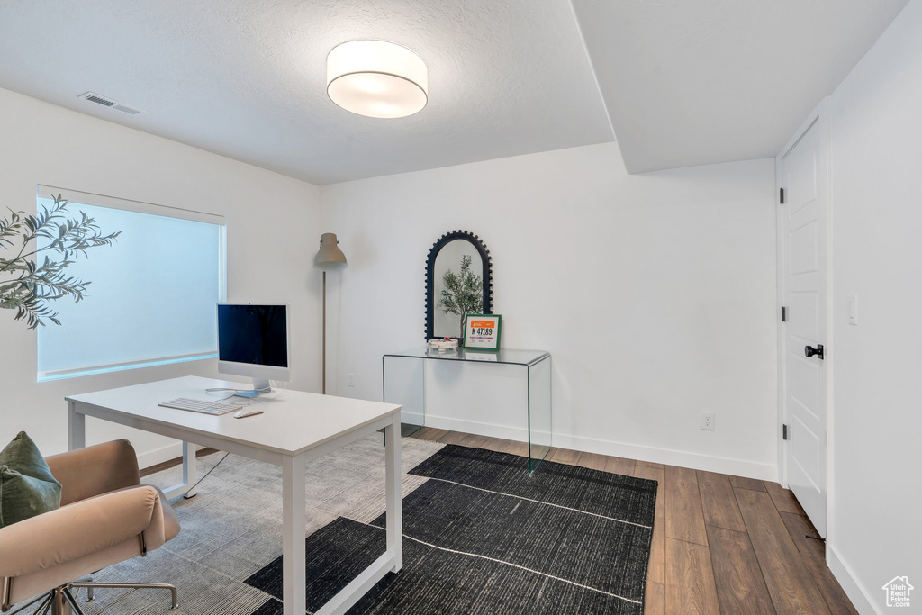 Home office with hardwood / wood-style floors and baseboards