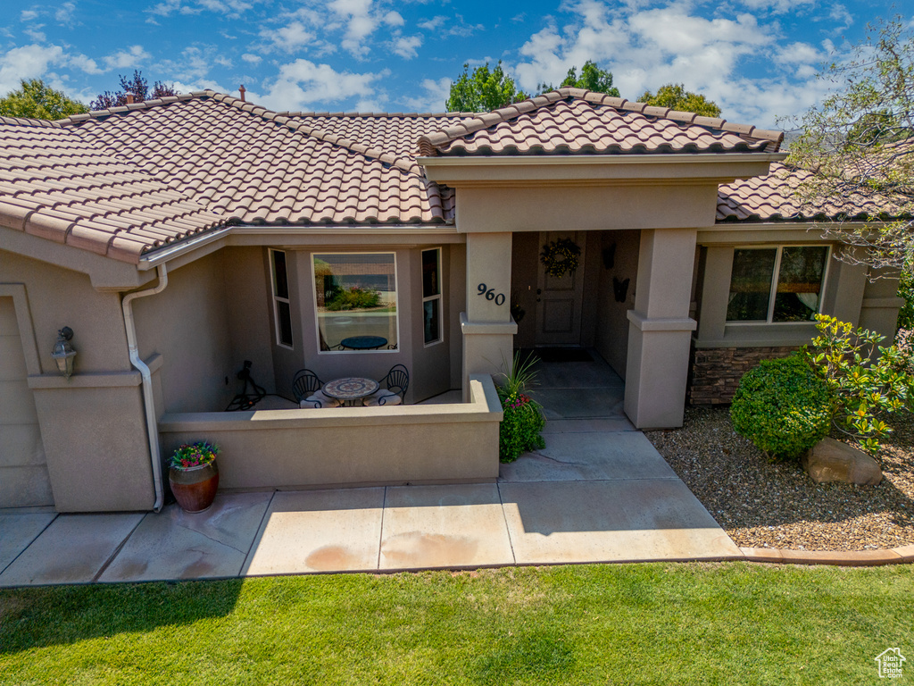 View of front facade with stucco siding and a tile roof