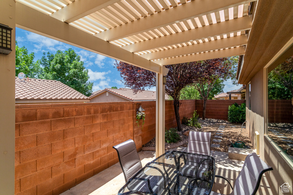 Fenced backyard featuring a patio area and a pergola