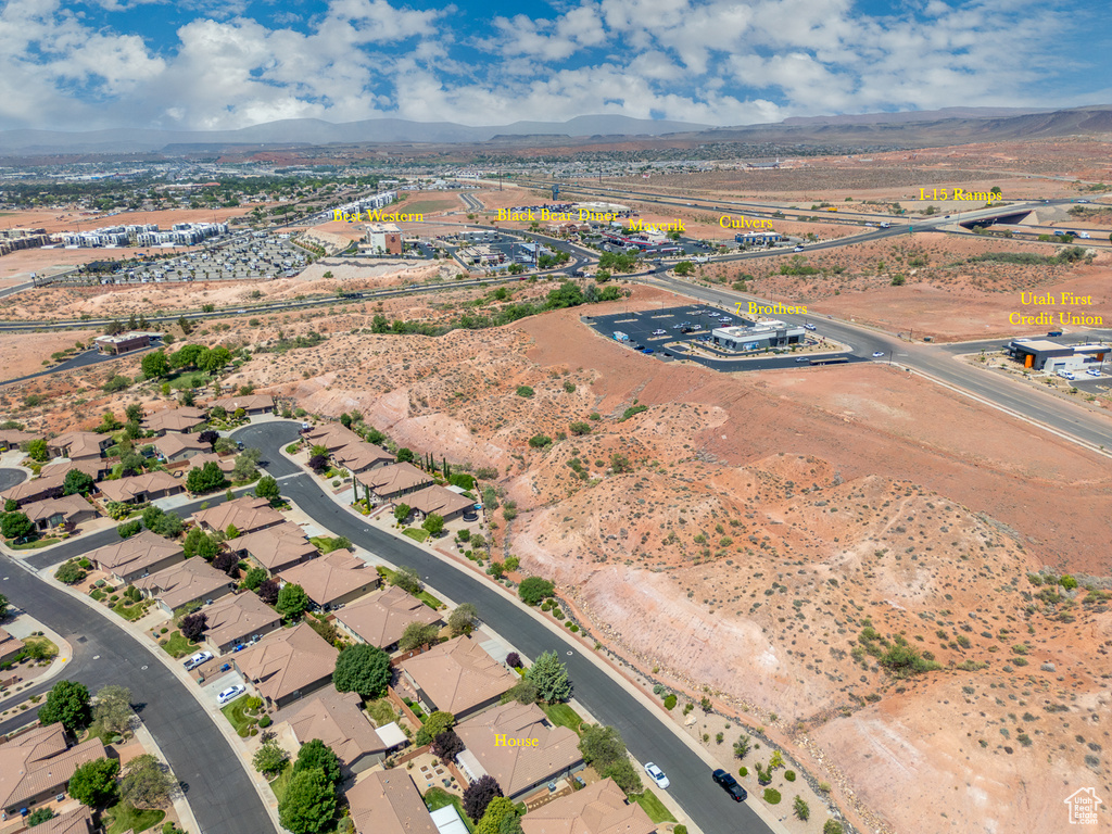 Aerial view of property and surrounding area with a mountain backdrop