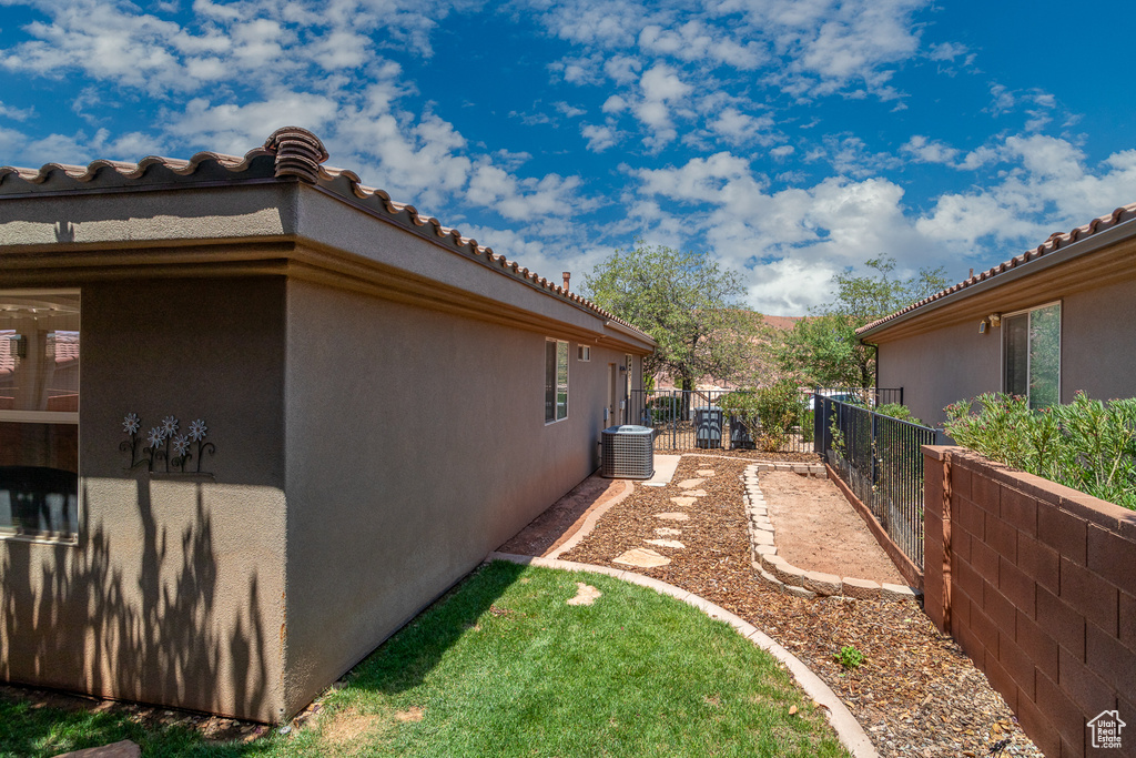 View of property exterior with stucco siding and a tile roof