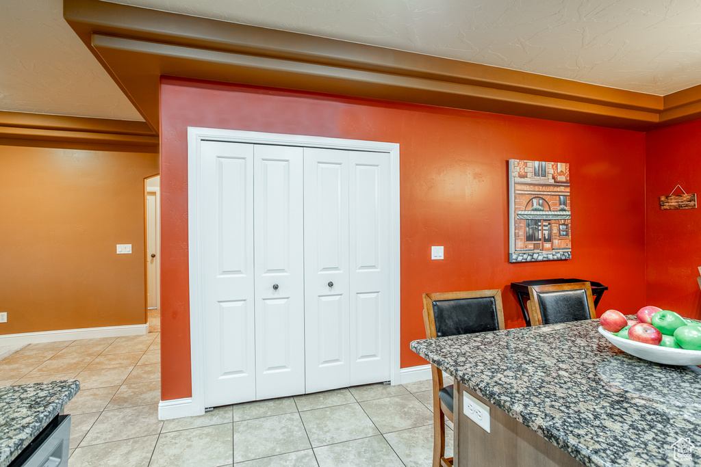 Dining space featuring light tile patterned flooring and baseboards