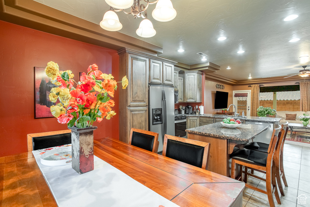 Dining space featuring light tile patterned floors, a chandelier, recessed lighting, and a ceiling fan
