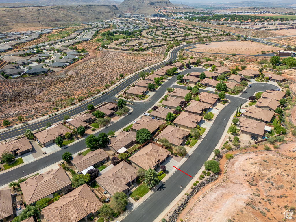 Aerial view of property and surrounding area with mountains and nearby suburban area