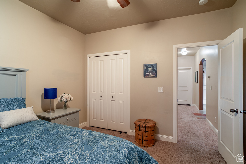 Bedroom featuring carpet floors, a closet, and ceiling fan