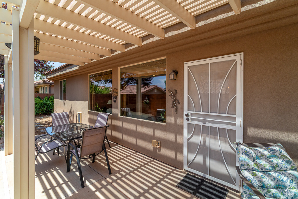 View of patio featuring outdoor dining area and a pergola