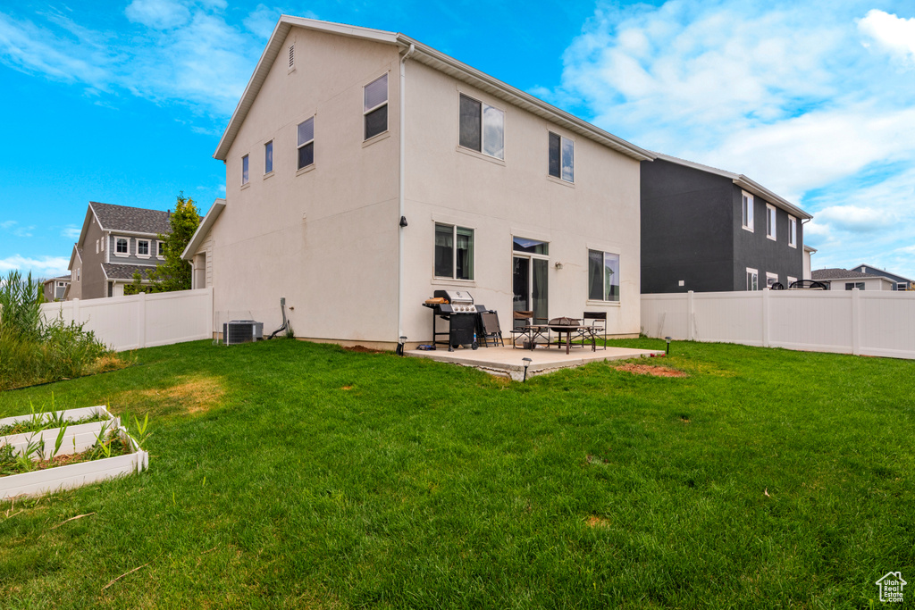 Rear view of house featuring a fenced backyard, a patio area, and stucco siding