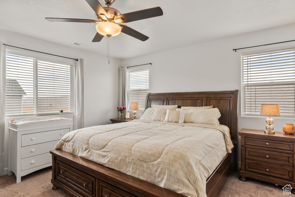 Bedroom featuring light colored carpet and ceiling fan