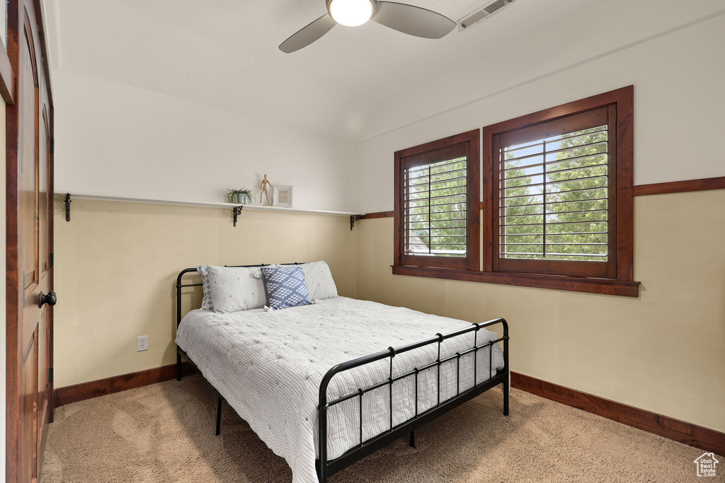 Carpeted bedroom featuring baseboards and ceiling fan