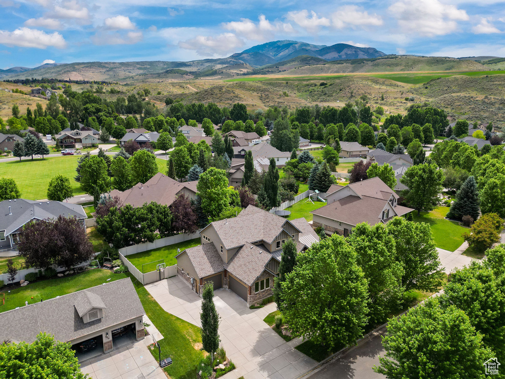 Aerial view of residential area featuring a mountainous background