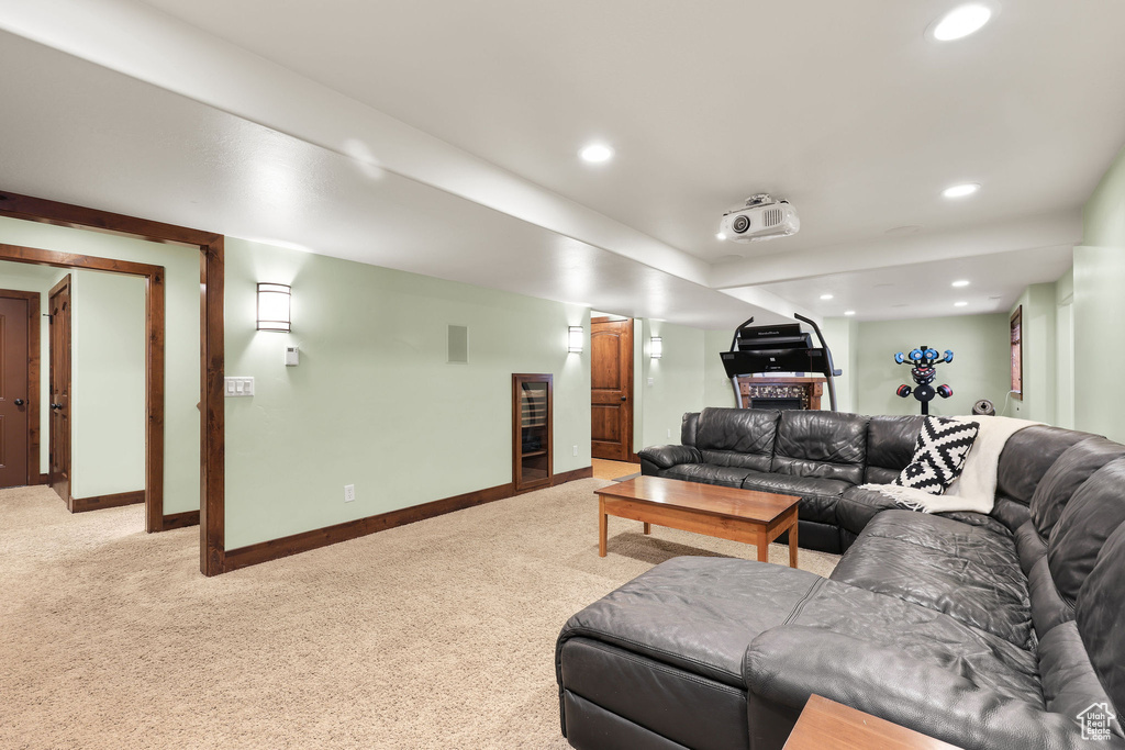Living area featuring light colored carpet and recessed lighting