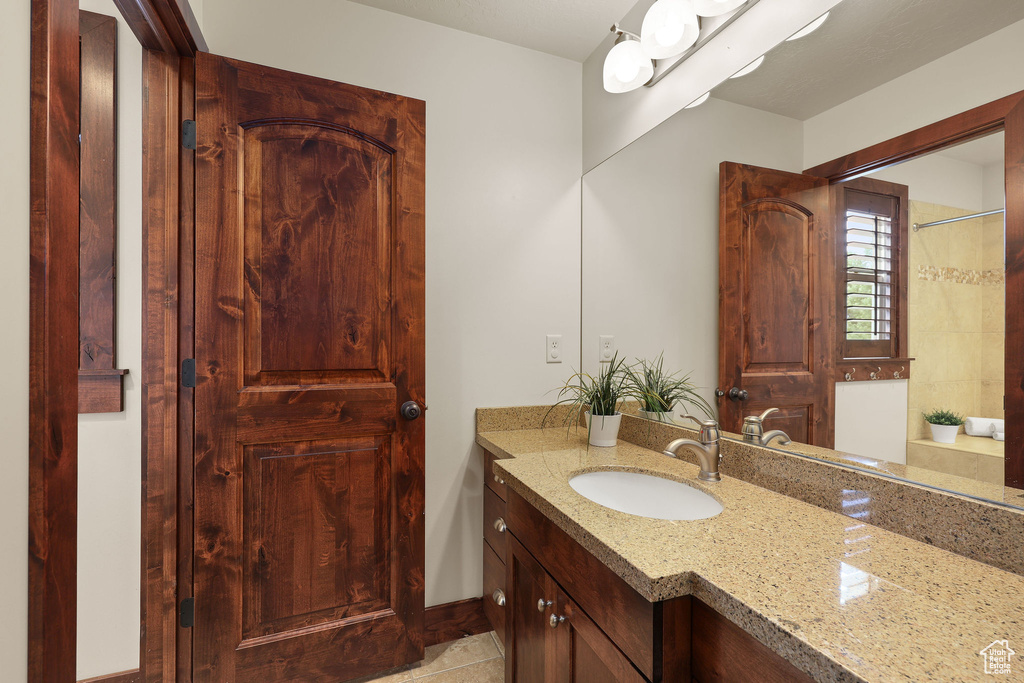 Bathroom with vanity and a shower