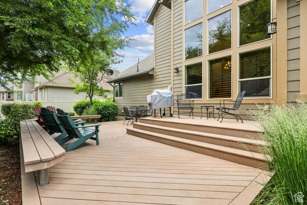 Wooden deck featuring a grill