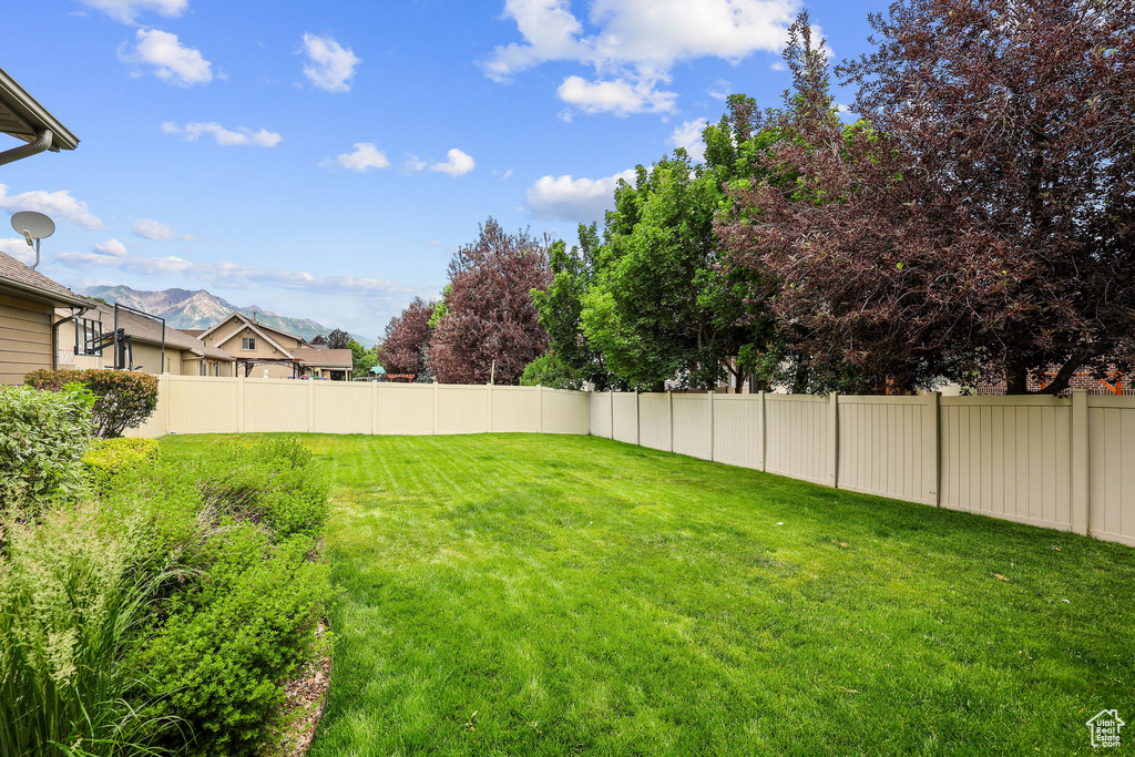 Fenced backyard with a mountain view