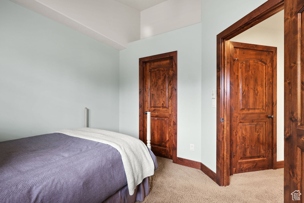 Bedroom with carpet flooring and baseboards