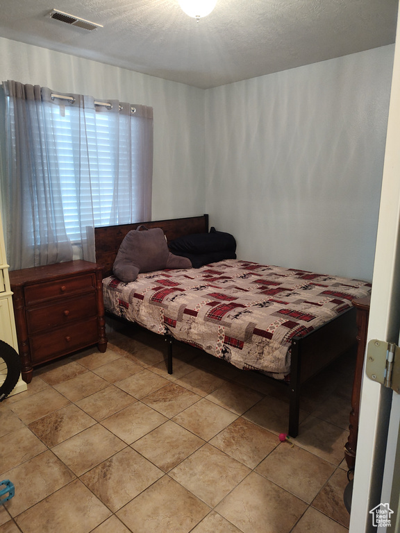Bedroom with a textured ceiling