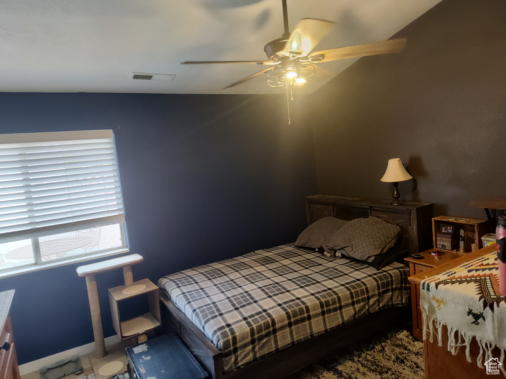 Bedroom featuring a ceiling fan and baseboards